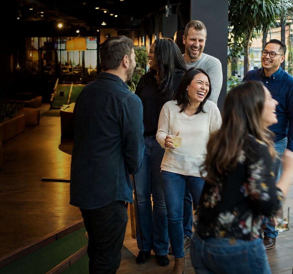 Coworkers enjoying a company outing at a social venue